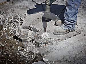 Man drilling cement concrete road