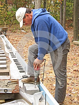 Man drilling concrete block