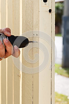 Man Drilling Gate Post