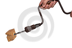 Man drilling a hole in a piece of woodwork with antique hand drill chest lyre and a clamped new wood bit. Clipping path. Macro.