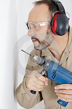 man drilling wall