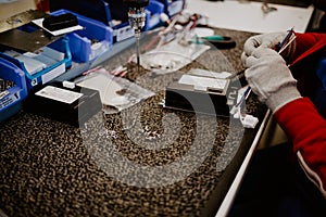 Man drilling wood with battery power Drill on the table at home