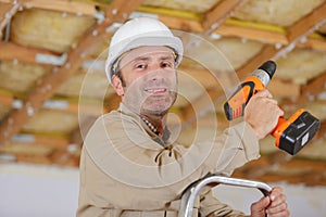 man drilling wood structure