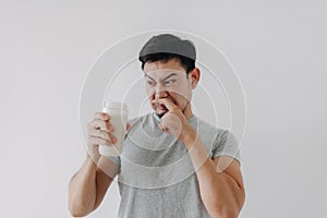 Man drink bad taste of protein chicken shake for health  on white.