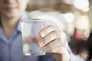 Man drink fresh cold pure water in glass