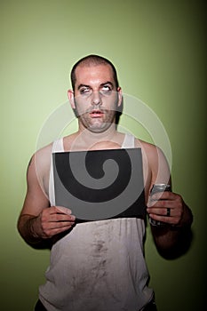 Man with drink in mugshot