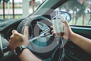 Man drinking alcohol while driving