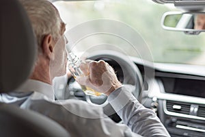 Man drinking alcohol and driving