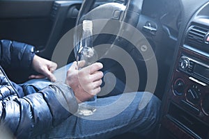 Man drinking alcohol while driving a car