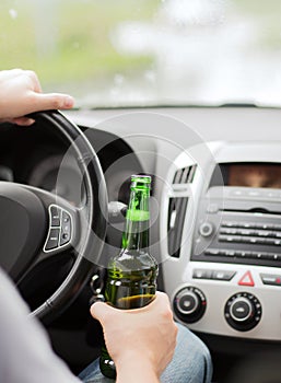 Man drinking alcohol while driving the car