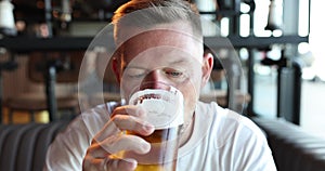 Man drinking beer at bar concept