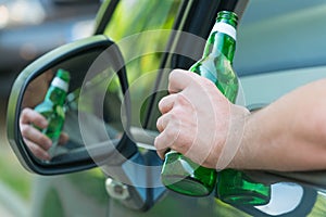 Man drinking beer in a car