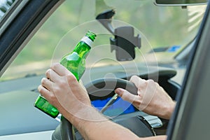 Man drinking beer in a car