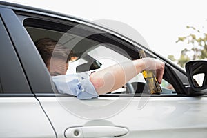 Man drinking beer while driving