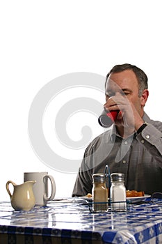 Man drinking beverage in a diner