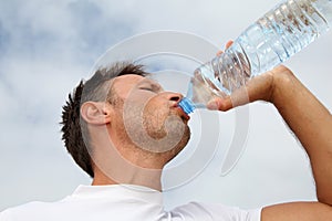 Man drinking from bottle of water