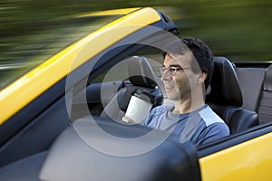 Man drinking coffee while driving