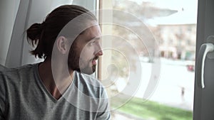 Man Drinking Coffee And Enjoying View From Window