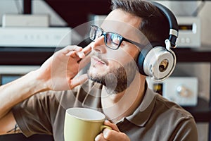 Man drinking coffee and listening to music