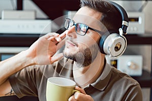 Man drinking coffee and listening to music photo