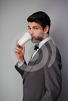 Man drinking coffee and looking at camera