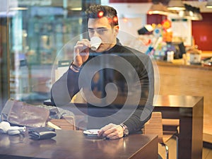 Man Drinking Coffee from Outside of the Bar Window