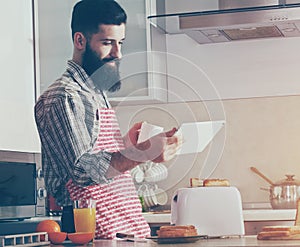 Man drinking coffee or tea and using digital tablet