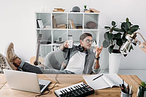 Man drinking coffee at workplace photo