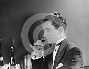 Man drinking glass of liqueur