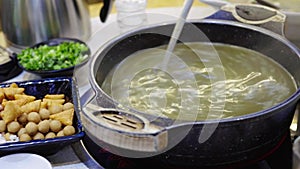 A man is drinking Guilin specialties in Guangxi, a soup beaten with tea leaves and oil