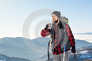 Man drinking from a hip flask on a hiking trip