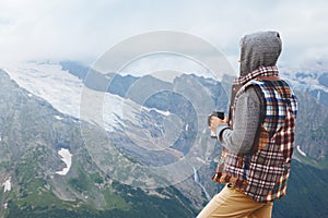 Man drinking hot coffee in mountains