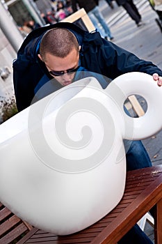 Man drinking from huge cup