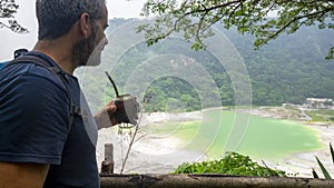 Man drinking Mate at Laguna de Alegria at the Tecapa volcano, El Salvador photo