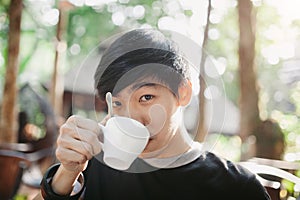 A man drinking on the morning coffee in sunshine light