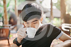 A man drinking on the morning coffee in sunshine light