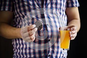 Man drinking orange soda and eating sweets