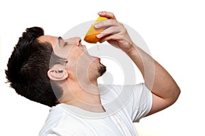 Man drinking out of grapefruit