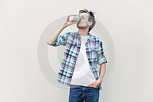 Man drinking takeaway aromatic coffee, needs energy for work, enjoying hot beverage.