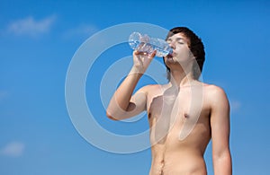 man is drinking water from the bottle