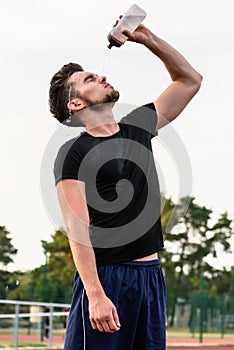 Man drinking from water bottle during sports