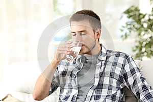 Man drinking water at home