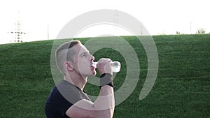 Man drinking water after jogging