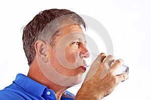 Man drinking water out of a glass