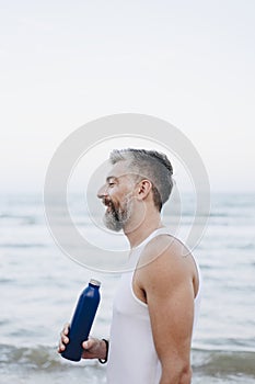 Man drinking water to rehydrate