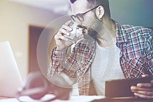 Man drinking water and working with digital tablet