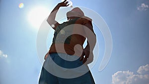 Man drinks water, intense heat, drinking water in the sun, sunstroke