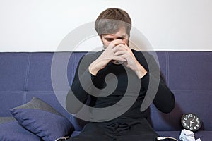 A man drinks water in a psychologists office. Young man with psychological problems in consultation with a doctor