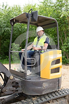 man driver excavator loader machine during earthmoving works outdoors at construction