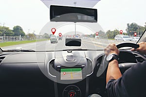 Man driver hands holding the car steering panel with map gps navigation inside car and pins or gps map on vehicles on the highway